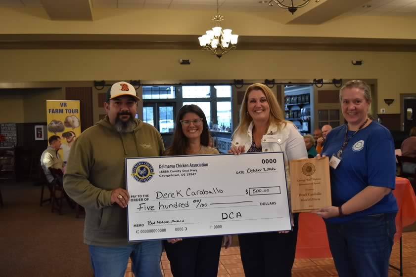 Derek and Pamela Caraballo, at left, receive the George ‘Bud’ Malone Award from executive director Holly Porter and agricultural conservation specialist Liz Warren.